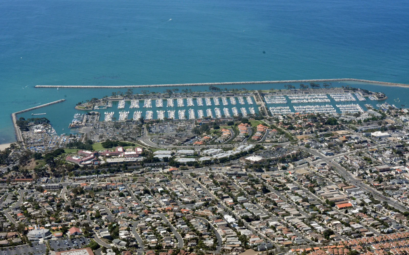 Dana Point Harbor with sailboats and marina facilities viewed from above